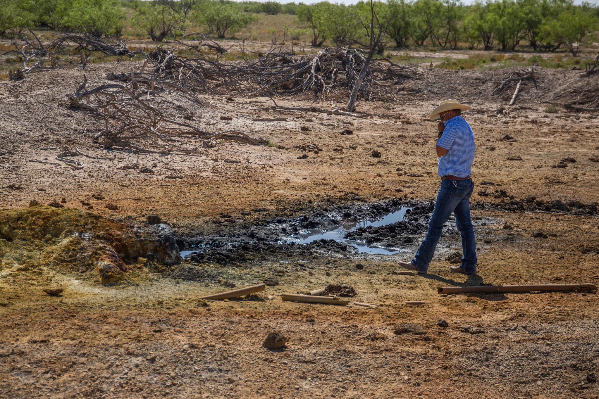 a man standing at the edge of a well covering his nose and mouth